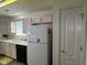 Bright kitchen with laminate floors, white countertops and a double sink at 11523 Coastal Way, Indianapolis, IN 46229