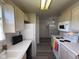 View of kitchen featuring white appliances and laminate flooring at 11523 Coastal Way, Indianapolis, IN 46229