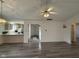 Open-concept living room with hardwood floors adjoining kitchen at 11523 Coastal Way, Indianapolis, IN 46229