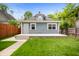 Backyard view of a house featuring a concrete patio, stairs and a grass lawn at 117 S Spencer Ave, Indianapolis, IN 46219