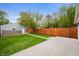 Large backyard featuring a well-maintained lawn, privacy fence, and detached garage at 117 S Spencer Ave, Indianapolis, IN 46219