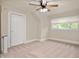 Cozy bedroom featuring a ceiling fan, neutral paint, and a bright window at 117 S Spencer Ave, Indianapolis, IN 46219