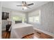 Charming bedroom with patterned wallpaper, wood floors, and plenty of natural light at 117 S Spencer Ave, Indianapolis, IN 46219