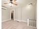 Bedroom showing a ceiling fan, neutral paint, and doorway to the bathroom at 117 S Spencer Ave, Indianapolis, IN 46219