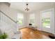 Bright foyer with hardwood floors, staircase, and window bench seating at 117 S Spencer Ave, Indianapolis, IN 46219