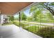 Spacious covered front porch with decorative railing offering serene neighborhood views at 117 S Spencer Ave, Indianapolis, IN 46219