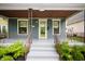 Inviting covered front porch with decorative railing and steps leading to the front door at 117 S Spencer Ave, Indianapolis, IN 46219