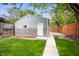 Detached garage with a well-kept lawn and partial view of a wooden fence at 117 S Spencer Ave, Indianapolis, IN 46219