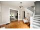 Open-concept living room with hardwood floors and staircase at 117 S Spencer Ave, Indianapolis, IN 46219