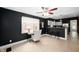 Living space with ceiling fan, desk, bar stool seating, and modern lighting at 117 S Spencer Ave, Indianapolis, IN 46219