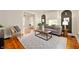 Well-lit living room with hardwood floors, plush seating, and an eye-catching coffee table at 117 S Spencer Ave, Indianapolis, IN 46219