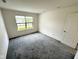 Bright bedroom with a large window offering natural light and a view, plus ample space for comfortable living at 11711 Whisper Cove Dr, Fishers, IN 46037