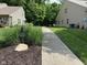 View of the front yard and adjacent building at 11711 Whisper Cove Dr, Fishers, IN 46037