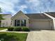 Charming single-story home featuring a brick facade, blue shutters, and an attached two-car garage at 11711 Whisper Cove Dr, Fishers, IN 46037