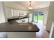 Bright kitchen featuring white cabinets, gray countertops, and stainless steel appliances at 11711 Whisper Cove Dr, Fishers, IN 46037