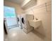 Functional laundry room featuring a sink, washer, dryer, and storage shelves for convenience at 11711 Whisper Cove Dr, Fishers, IN 46037