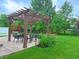 Relaxing backyard featuring a pergola with an outdoor dining area and manicured lawn at 12044 Bird Key Blvd, Fishers, IN 46037