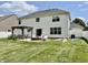 Large backyard featuring a stone fire pit, patio with pergola, and garden at 12044 Bird Key Blvd, Fishers, IN 46037