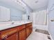 Bright, clean bathroom with double vanity, bathtub-shower combo, and neutral tile at 12044 Bird Key Blvd, Fishers, IN 46037