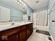 Bathroom featuring a double sink vanity, bath, and tile flooring at 12044 Bird Key Blvd, Fishers, IN 46037