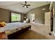 Spacious carpeted bedroom with vaulted ceiling, ceiling fan, and an adjacent bathroom at 12044 Bird Key Blvd, Fishers, IN 46037