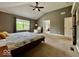 Relax in this comfortable bedroom featuring plush carpet, a ceiling fan, and large windows at 12044 Bird Key Blvd, Fishers, IN 46037