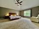 Spacious bedroom with tray ceilings, ceiling fan, and large windows provides ample natural light at 12044 Bird Key Blvd, Fishers, IN 46037