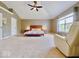 Spacious bedroom featuring a ceiling fan, large window, and neutral carpeting at 12044 Bird Key Blvd, Fishers, IN 46037