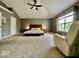 A carpeted bedroom features neutral walls, large windows, and a comfortable recliner at 12044 Bird Key Blvd, Fishers, IN 46037