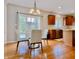 Open concept dining area with hardwood floors, modern lighting and view to the kitchen at 12044 Bird Key Blvd, Fishers, IN 46037