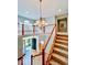 Grand foyer with staircase, chandelier, and view of the front entrance at 12044 Bird Key Blvd, Fishers, IN 46037