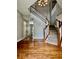 A grand foyer with hardwood floors and a staircase featuring white railings and wood trim at 12044 Bird Key Blvd, Fishers, IN 46037