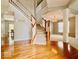 Stunning foyer with hardwood floors, a staircase, and decorative pillars leading to other living areas at 12044 Bird Key Blvd, Fishers, IN 46037