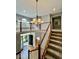 Grand foyer showcasing a stunning chandelier, staircase, and views to the front door and second floor at 12044 Bird Key Blvd, Fishers, IN 46037