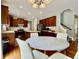Bright eat-in kitchen with hardwood floors, wooden cabinetry, stainless appliances, and white marble dining table at 12044 Bird Key Blvd, Fishers, IN 46037