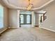 A bright living room with neutral carpet, columns, modern lighting, and ample space for decor at 12044 Bird Key Blvd, Fishers, IN 46037
