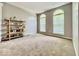 A spacious living room with carpet, a large window, and a decorative shelf at 12044 Bird Key Blvd, Fishers, IN 46037