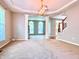 Expansive living room with decorative columns, large windows, and neutral carpet at 12044 Bird Key Blvd, Fishers, IN 46037