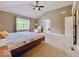 Large main bedroom with ceiling fan, window, and an ensuite bathroom at 12044 Bird Key Blvd, Fishers, IN 46037