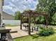 An outdoor patio area with a pergola, dining table, and garden at 12044 Bird Key Blvd, Fishers, IN 46037