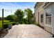 Backyard concrete patio with string lights and green landscaping to create a relaxing outdoor living space at 12331 Chiseled Stone Dr, Fishers, IN 46037