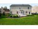 Large backyard with mature trees, a patio, and green grass at 12331 Chiseled Stone Dr, Fishers, IN 46037