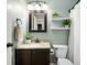 Bathroom with dark vanity, granite counters, framed mirror, and bright lighting at 12331 Chiseled Stone Dr, Fishers, IN 46037