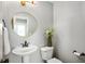 Stylish powder room featuring a round mirror, pedestal sink, and decorative accents at 12331 Chiseled Stone Dr, Fishers, IN 46037