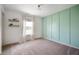 Stylish bedroom with green accent wall, shelving, and a window with lots of natural light at 12331 Chiseled Stone Dr, Fishers, IN 46037