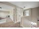 Hallway with neutral carpet and paint leads to bedrooms with open doorways and white doors at 12331 Chiseled Stone Dr, Fishers, IN 46037