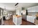 Spacious kitchen with stainless steel appliances, granite countertops, white cabinets and a butcher block island at 12331 Chiseled Stone Dr, Fishers, IN 46037