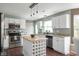 Open kitchen with white cabinets, stainless steel appliances, granite countertops, and a butcher block island at 12331 Chiseled Stone Dr, Fishers, IN 46037