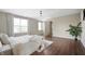 Hardwood floors and natural light from several windows make for a calming primary bedroom at 12331 Chiseled Stone Dr, Fishers, IN 46037