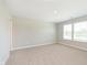 Spacious bedroom with neutral carpeting, light walls, and natural light from the double windows at 1237 Langham St, Avon, IN 46123